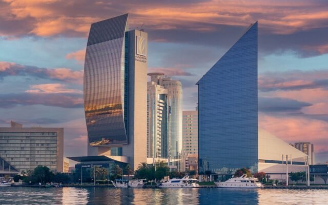 Stunning view of Dubai's skyline with modern skyscrapers and a dramatic sunset.