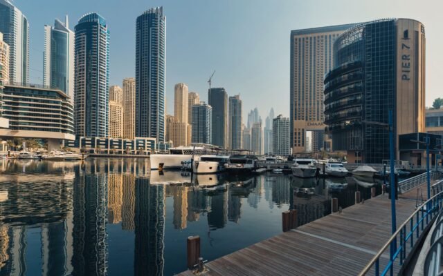 Explore the breathtaking skyline of Dubai Marina with iconic skyscrapers and luxury yachts.