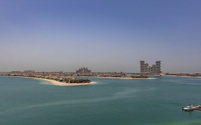 Aerial view of Palm Jumeirah in Dubai showcasing modern architecture and serene waters.